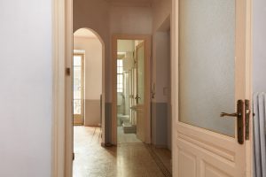 Old apartment interior view with open wooden door
