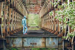 Sad man on the abandoned bridge